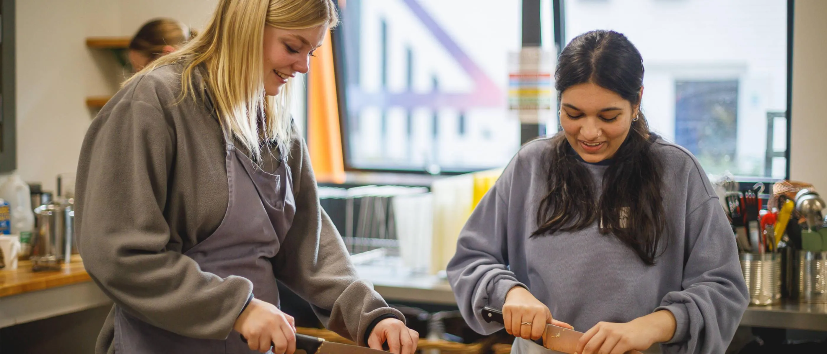 Two people preparing food together in the Square Food Foundation kitchen